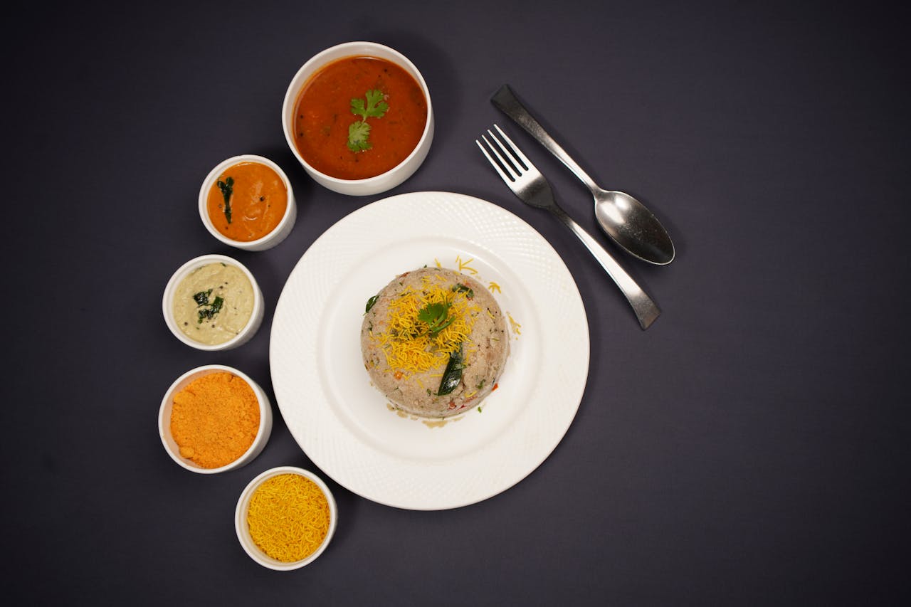services-02 Delicious Indian Upma served with various chutneys and sambhar, perfect for food enthusiasts.